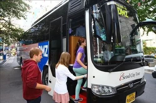 Travelers boarding a DMZ tour bus in Seoul