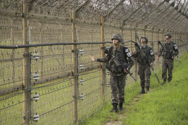 South Korean soldiers patrolling along the DMZ border fence
