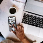 transfer iphone photos to computer — laptop and smartphone on outdoor desk